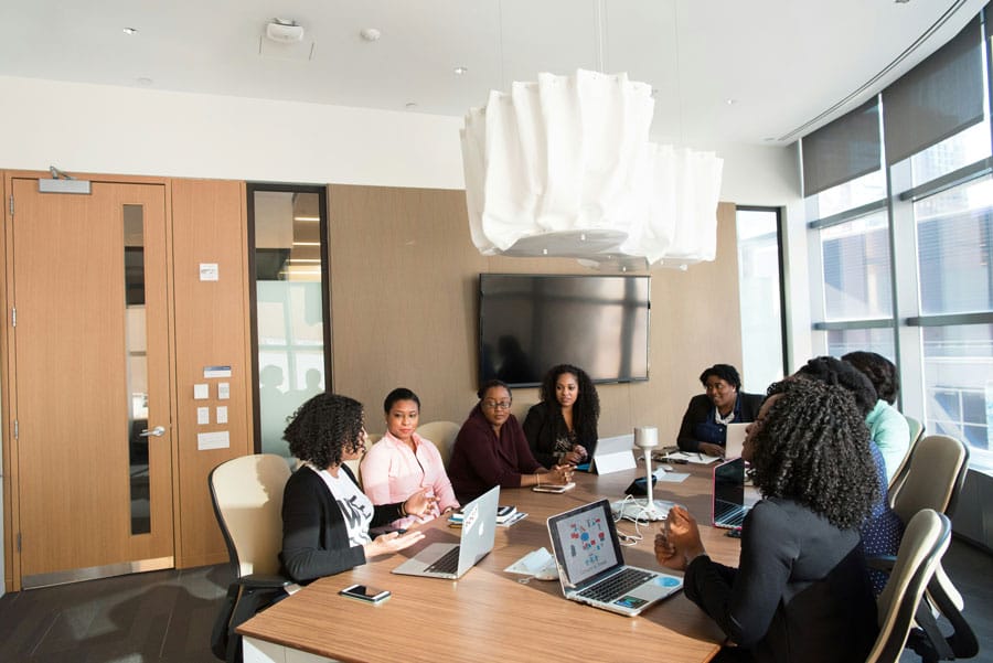 Women executive leaders in a boardroom discussion