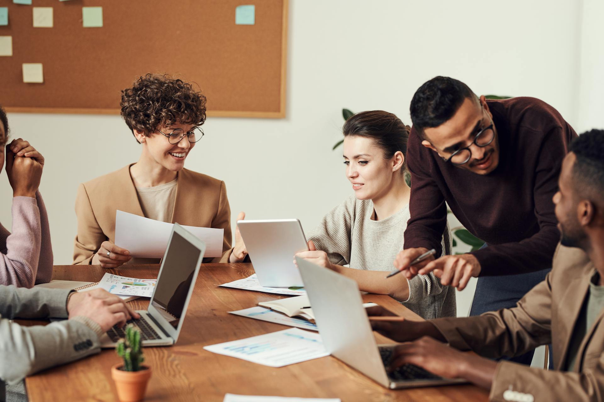 Executive colleagues engaging in a meeting discussion around a table