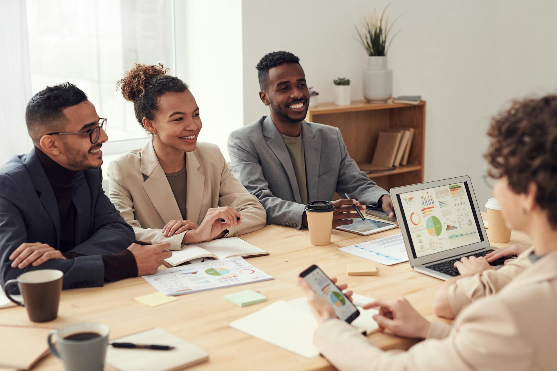 A group of young executives in a boardroom discussion