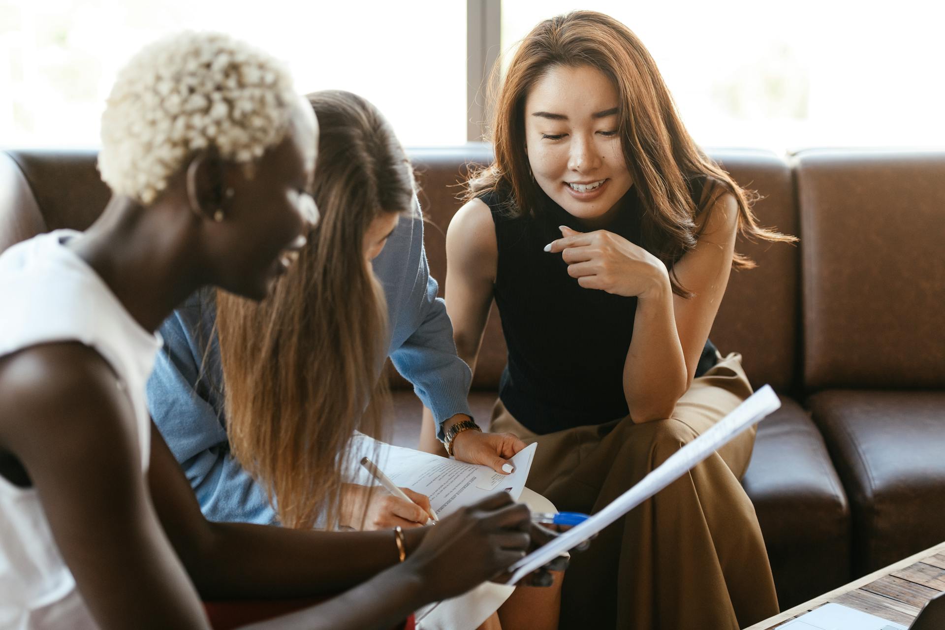 A group of different ethnicity women executives in a casual discussion