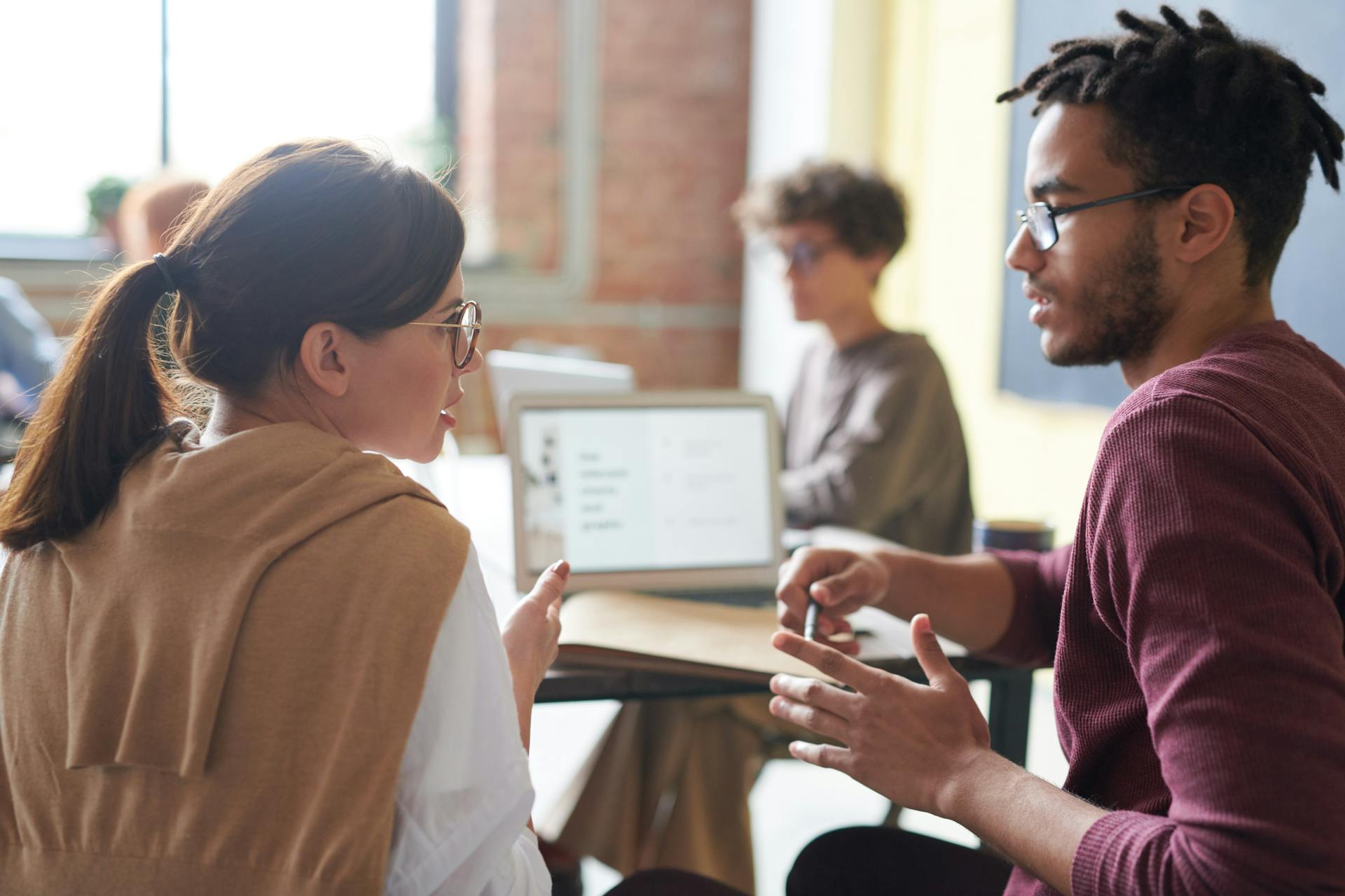 Two different ethnicity young executives in a serious discussion